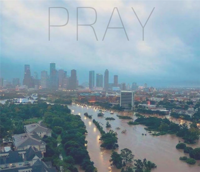 The flooded city of Houston with the word pray. 