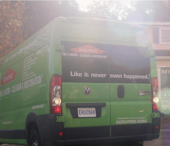 green Servpro work van parked outside of residential home 